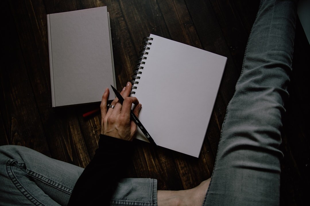 person writing in notebook