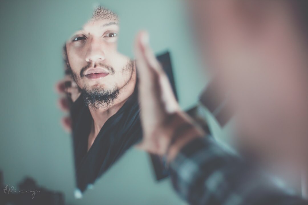 person reflecting in mirror